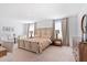 Bright main bedroom featuring a king bed, matching nightstands, and a dresser, illuminated by natural light at 2099 Derwent Dr, Davenport, FL 33896
