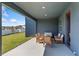 The covered patio has comfortable seating arrangements perfect for outdoor lounging and relaxation at 2099 Derwent Dr, Davenport, FL 33896