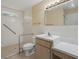 Accessible bathroom with tiled walk-in shower, grab bars, neutral walls and large vanity at 2200 Pine Needle Trl, Kissimmee, FL 34746