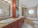 Bathroom with double vanity, bathtub, and walk-in shower offers a relaxing and functional space at 2200 Pine Needle Trl, Kissimmee, FL 34746