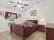 Comfortable bedroom with ceiling fan, warm colors, tiled floor and natural lighting at 2200 Pine Needle Trl, Kissimmee, FL 34746