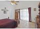 Bedroom featuring a ceiling fan, tile floors, and large windows with curtains at 2200 Pine Needle Trl, Kissimmee, FL 34746
