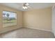 A naturally lit bedroom with a window and a ceiling fan, offering ample space and comfort at 2200 Pine Needle Trl, Kissimmee, FL 34746
