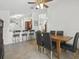 Open-concept dining room with counter seating, tiled flooring and bright interior at 2200 Pine Needle Trl, Kissimmee, FL 34746