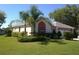 Charming single-story home featuring a well-manicured lawn and lush landscaping at 2200 Pine Needle Trl, Kissimmee, FL 34746