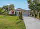 Inviting single-story home with a well-kept lawn and a long driveway at 2200 Pine Needle Trl, Kissimmee, FL 34746