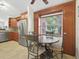 Bright breakfast nook with a window view, stainless steel refrigerator and matching cabinets at 2200 Pine Needle Trl, Kissimmee, FL 34746