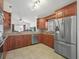 Modern kitchen with stainless steel appliances and wooden cabinets at 2200 Pine Needle Trl, Kissimmee, FL 34746