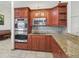 Updated kitchen features stainless steel appliances, granite countertops and mosaic backsplash at 2200 Pine Needle Trl, Kissimmee, FL 34746
