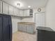 Compact kitchenette provides functionality with ample cabinetry, sink, countertop, and convenient appliances at 2200 Pine Needle Trl, Kissimmee, FL 34746