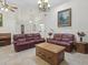 Large living room with tile floors, comfortable seating, and piano at 2200 Pine Needle Trl, Kissimmee, FL 34746