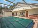 A covered pool area with a large pool cover, a swing, hot tub, and access to the home at 2200 Pine Needle Trl, Kissimmee, FL 34746