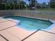 A refreshing pool with a bright blue trim and an inviting, geometric design at 2200 Pine Needle Trl, Kissimmee, FL 34746