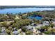 Scenic aerial image featuring a lakeside community with homes nestled among abundant trees and tranquil waters at 2723 Beacon St, Eustis, FL 32726