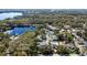 Panoramic aerial view of a residential community near a lake, showcasing the tree coverage and surrounding landscape at 2723 Beacon St, Eustis, FL 32726