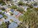 Aerial view of a charming single-story home nestled among lush trees in a peaceful neighborhood at 2723 Beacon St, Eustis, FL 32726