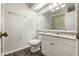 Updated bathroom featuring granite countertop vanity, a toilet, and large mirror at 2723 Beacon St, Eustis, FL 32726
