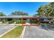 Charming single-story home with a well-manicured lawn, blue shutters, and a neatly trimmed front hedge at 2723 Beacon St, Eustis, FL 32726