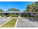 Charming townhome exterior featuring manicured landscaping, blue shutters, and convenient parking at 2723 Beacon St, Eustis, FL 32726