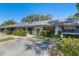 Inviting townhome exterior featuring manicured greenery, blue shutters, and designated parking at 2723 Beacon St, Eustis, FL 32726