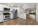 Modern kitchen featuring stainless steel appliances, a breakfast bar, and stylish countertops at 2723 Beacon St, Eustis, FL 32726