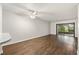 Bright living room with wood-style flooring, ceiling fan, and sliding glass doors to the lanai at 2723 Beacon St, Eustis, FL 32726