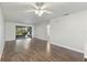 Open living space with modern flooring, ceiling fan, and sliding glass doors to the screened lanai at 2723 Beacon St, Eustis, FL 32726
