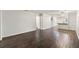 Spacious, open-concept living area with wood-look floors and views of the kitchen and hall at 2723 Beacon St, Eustis, FL 32726