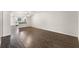 Inviting living area featuring wood-look flooring with a view of the kitchen and dining area at 2723 Beacon St, Eustis, FL 32726