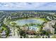 An aerial view of a pool, a waterpark, a lake, and residential buildings at 2784 Almaton Loop # 301, Kissimmee, FL 34747