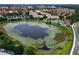 Gorgeous aerial view of a resort community with a lily pad filled lake and luxurious pool and buildings at 2784 Almaton Loop # 301, Kissimmee, FL 34747