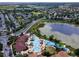 Aerial view of a resort style community pool with a slide, lazy river, parking and surrounding residential neighborhood at 2784 Almaton Loop # 301, Kissimmee, FL 34747