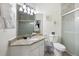 Bright bathroom featuring a granite countertop vanity and glass door shower at 2784 Almaton Loop # 301, Kissimmee, FL 34747