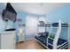 Blue bedroom with bunk beds, a white dresser, and wall-mounted television at 2784 Almaton Loop # 301, Kissimmee, FL 34747