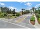 Welcoming entrance to Windsor Hills community, lined with palm trees and beautifully landscaped grounds at 2784 Almaton Loop # 301, Kissimmee, FL 34747