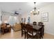 Open-concept living room and dining area with elegant chandelier and comfortable seating at 2784 Almaton Loop # 301, Kissimmee, FL 34747