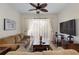 Comfortable living room with plush sofas, ceiling fan, and sliding glass doors to screened patio at 2784 Almaton Loop # 301, Kissimmee, FL 34747
