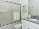 Bright bathroom features a shower over bath, a modern vanity and tile surround at 2807 Bookmark Dr, Kissimmee, FL 34746