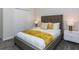 Cozy bedroom featuring stylish wallpaper, a queen bed, and elegant nightstands with lamps at 2807 Bookmark Dr, Kissimmee, FL 34746