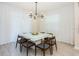 Elegant dining room with modern lighting, white table, and seating for six at 2807 Bookmark Dr, Kissimmee, FL 34746