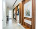 Inviting hallway featuring stylish decor, unique wall shelves, and neutral tile flooring at 2807 Bookmark Dr, Kissimmee, FL 34746