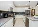Modern kitchen featuring sleek white cabinets, stainless steel appliances, and a stylish backsplash at 2807 Bookmark Dr, Kissimmee, FL 34746