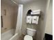 Bathroom features a tub with shower curtain, a toilet, and towels on a chrome rack at 3000 Maingate Ln # 227, Kissimmee, FL 34747