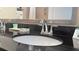 Modern bathroom sink with chrome faucet and reflective mirror featuring a black countertop at 3000 Maingate Ln # 227, Kissimmee, FL 34747