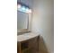 Traditional bathroom vanity with marble countertop and decorative lighting fixture at 3026 Bella Vista Dr, Davenport, FL 33897