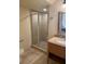 Modern bathroom with a walk-in shower and a sink with granite countertops at 3026 Bella Vista Dr, Davenport, FL 33897