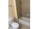 Neutral bathroom features a tiled shower and tub combination with a toilet at 3026 Bella Vista Dr, Davenport, FL 33897