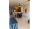Open concept dining area features a modern chandelier, seating for four, and neutral tile flooring at 3026 Bella Vista Dr, Davenport, FL 33897