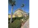 Two-story townhome with lush landscaping and mature palm trees at 3026 Bella Vista Dr, Davenport, FL 33897