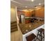 Well-lit kitchen boasts stainless steel appliances, granite countertops, and wood cabinets at 3026 Bella Vista Dr, Davenport, FL 33897